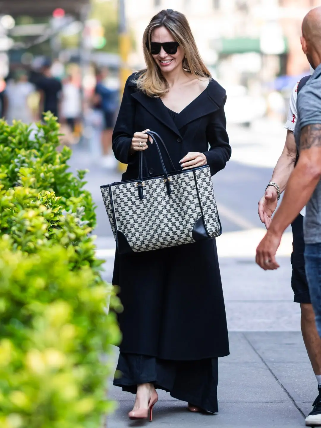 Angelina on street in a black slip dress