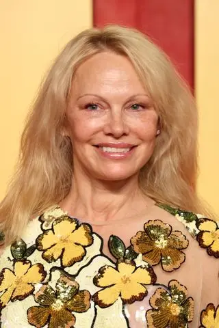 Pamela Anderson on the Vanity Fair Oscars Red Carpet wearing a floral dress