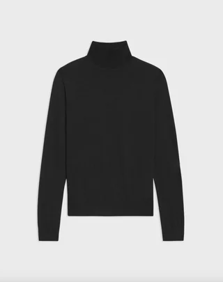 a black turtleneck on a plain backdrop