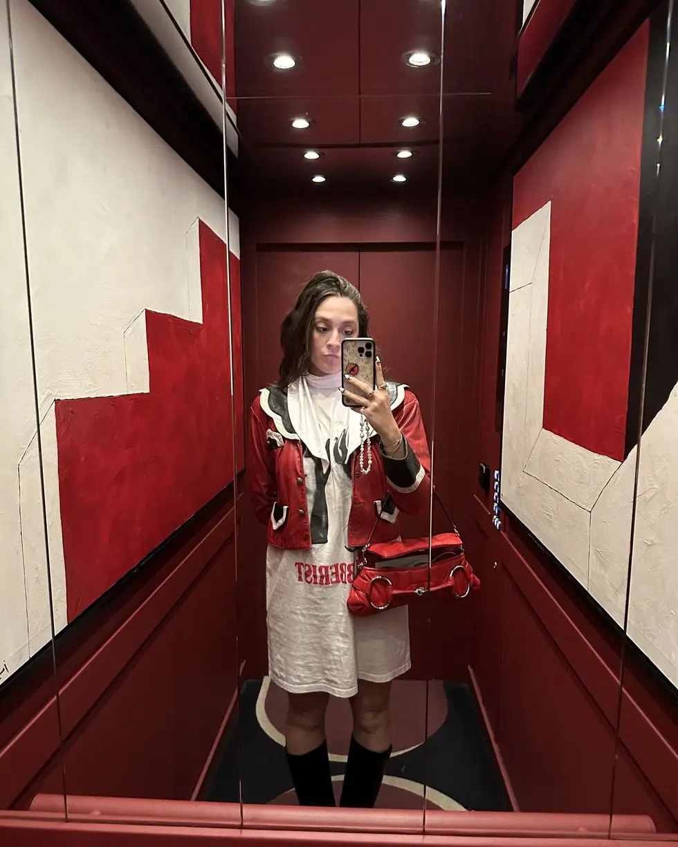 a woman taking a selfie in a mirror