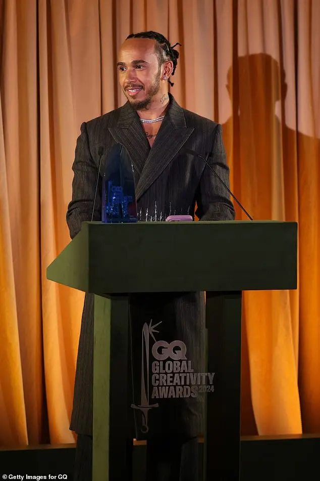 Lewis appeared in his element as he posed on the purple carpet before taking to the stage later in the evening where he accepted an award