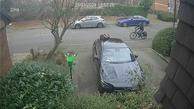 The crook wearing a flat cap, dark jacket, gloves, and denim jeans is cycling along a quiet suburban street when he notices the dark-coloured holdall