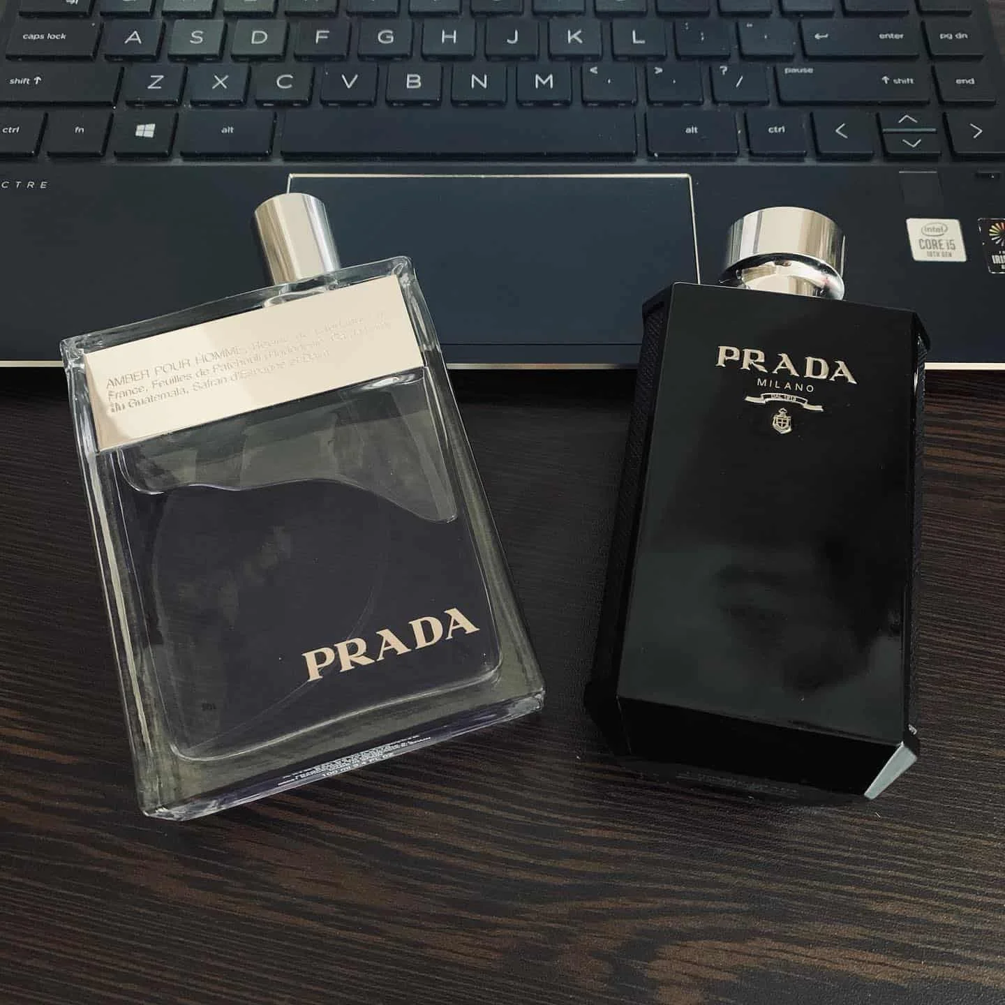 bottles of prada L'Homme and Amber Pour Homme colognes