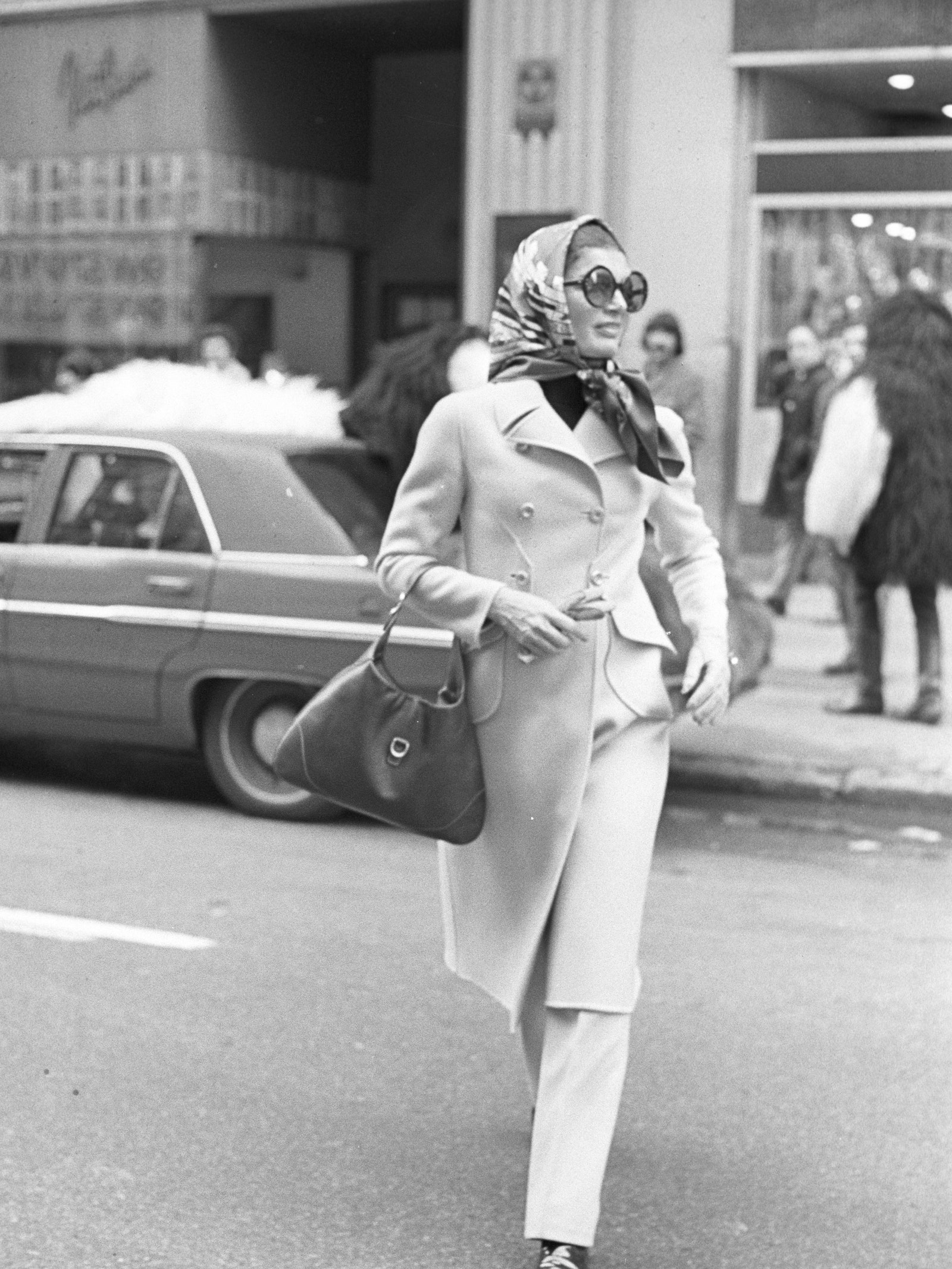 Image may contain Jacqueline Kennedy Onassis Accessories Bag Handbag Clothing Coat Purse Person and Walking