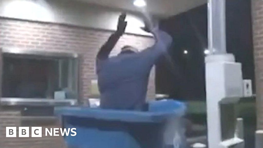 Watch bungling burglar fall into bin from roof