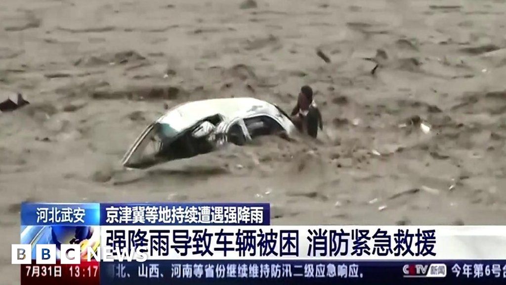 Man saved after car flips in raging floodwaters