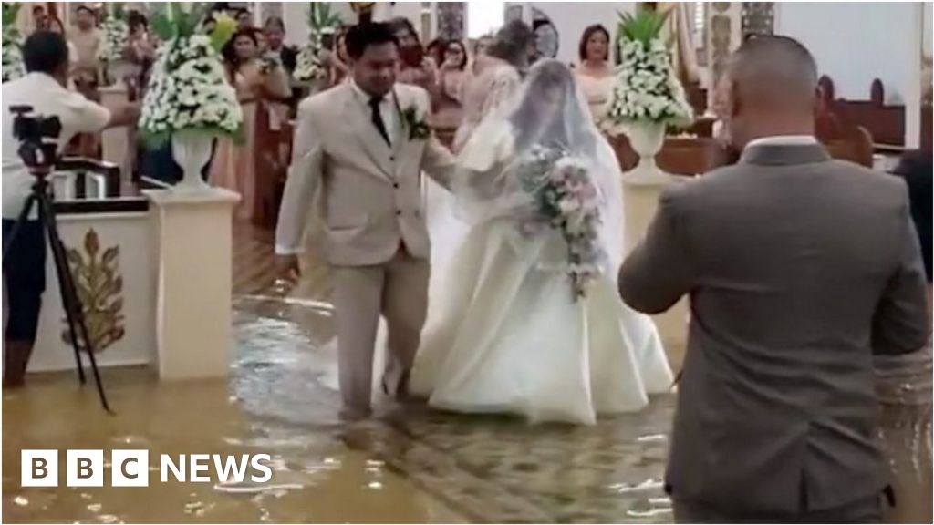 Watch: Bride walks down flooded aisle after typhoon