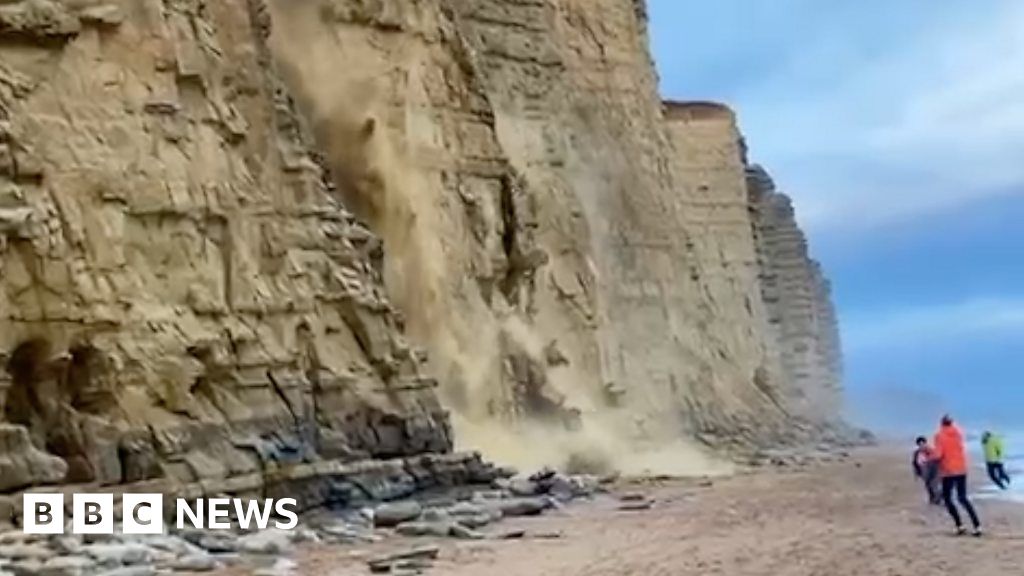 Watch: Moment beachgoers escape cliff collapse