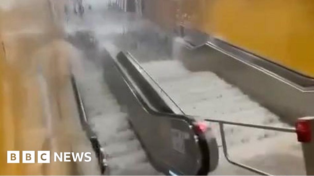 Watch: Flood waters surge down Frankfurt escalator