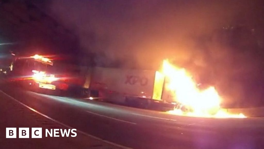 Moment police officer rescues driver from burning truck