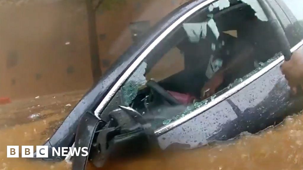 Officer rescues trapped driver in flooded car