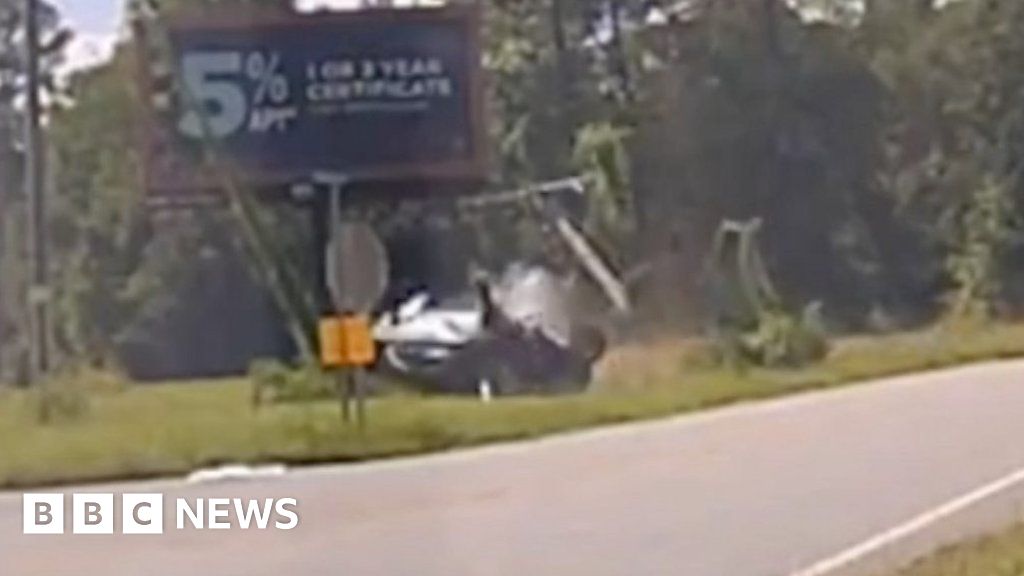 Video shows car rolling over and narrowly missing officer