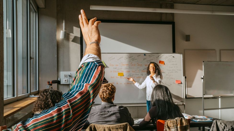 Why are women less likely to ask questions in public?