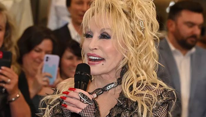 Dolly Parton Attends the Opening of Her Fashion Show and Helps Cut the Ribbon