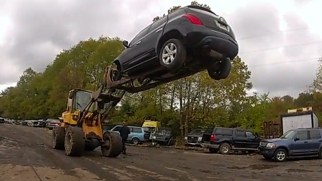 Video shows forklift suspending car 20 feet in air to stop theft suspect at Akron car lot