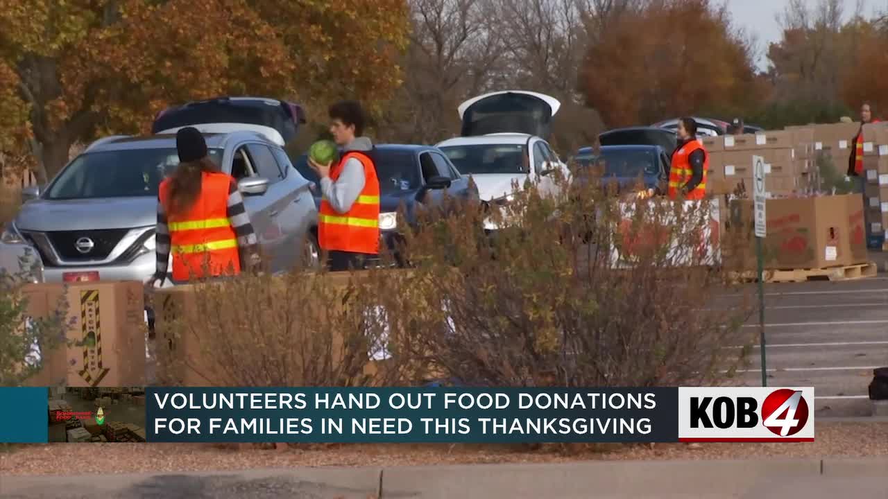 Volunteers hand out food donations for local families