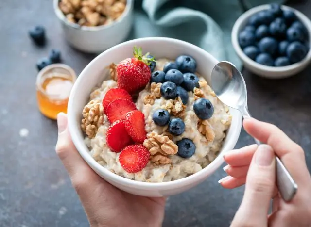 bowl of oatmeal with strawberries and blueberries and walnuts