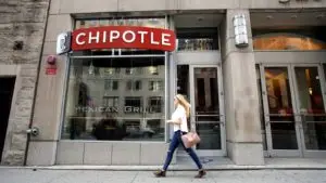 a pedestrian walks past a Chipotle