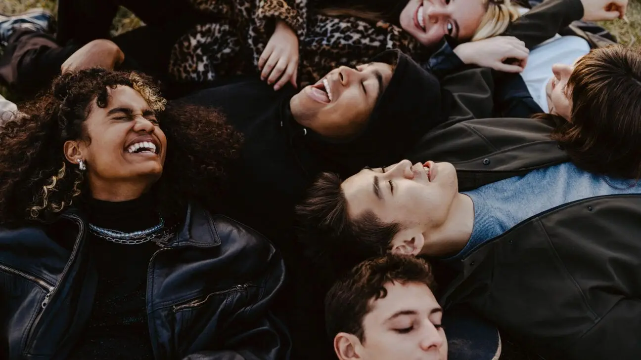 Group of adolescents lying down outside.