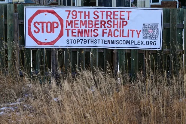 A sign on the fence of a home in Gunbarrel Estes neighborhood shows opposition to the proposed tennis complex in Boulder County on Friday. (Matthew Jonas/Staff Photographer)