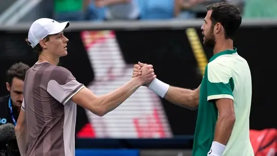 Jannik Sinner, left, of Italy is congratulated by Karen Khachanov of Russia following their fourth round match at the Australian Open tennis championships at Melbourne Park(AP)