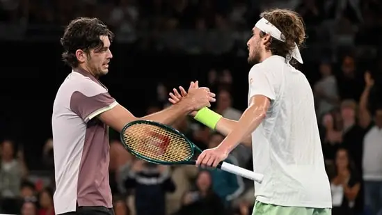 USA's Taylor Fritz (L) shakes hands with Greece's Stefanos Tsitsipas after their men's singles match on day eight of the Australian Open tennis tournament in Melbourne on January 21(AFP)