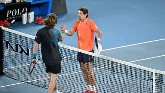 Russia's Andrey Rublev (L) shakes hands with Australia's Alex De Minaur after winning in the men's singles match on day eight of the Australian Open tennis tournament in Melbourne (AFP)