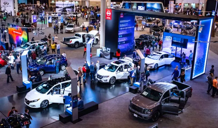 A convention floor filled with vehicles and attendees