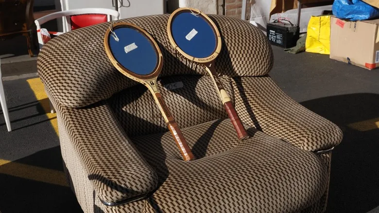 tennis racket mirrors on sofa