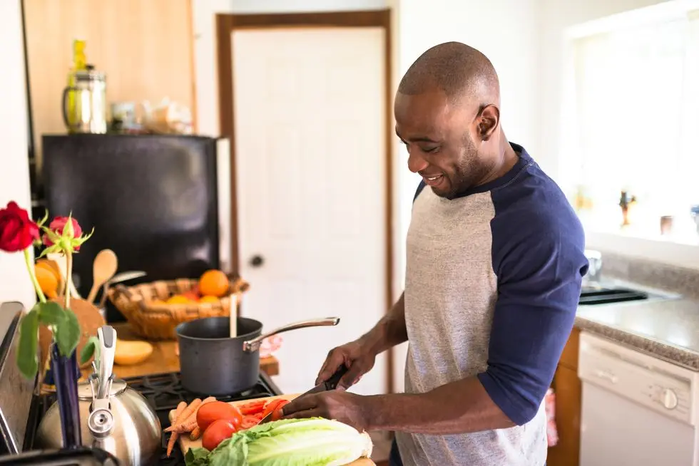 man standing happiness on the kitchen and preparing food