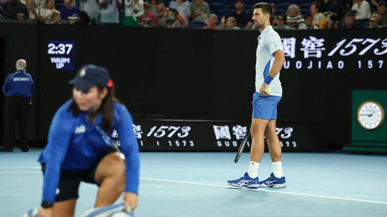 Novak Djokovic’s fourth-round match with Adrian Mannarino was his first day match after 15 consecutive night matches at Melbourne Park. But it rained anyway. (Photo by Martin KEEP / AFP)