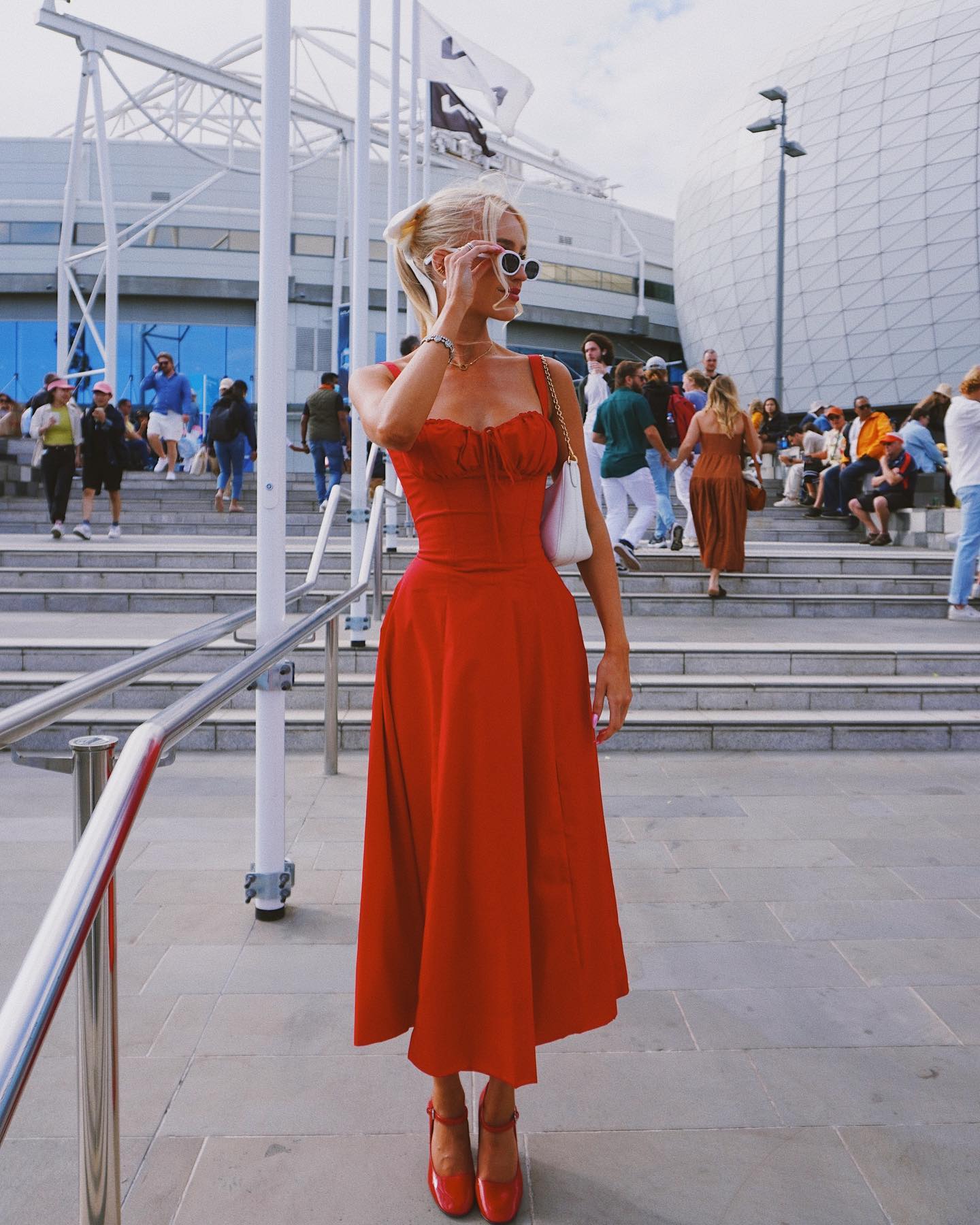 Glam tennis Wag Morgan Riddle stuns in flowing red dress at Australian Open