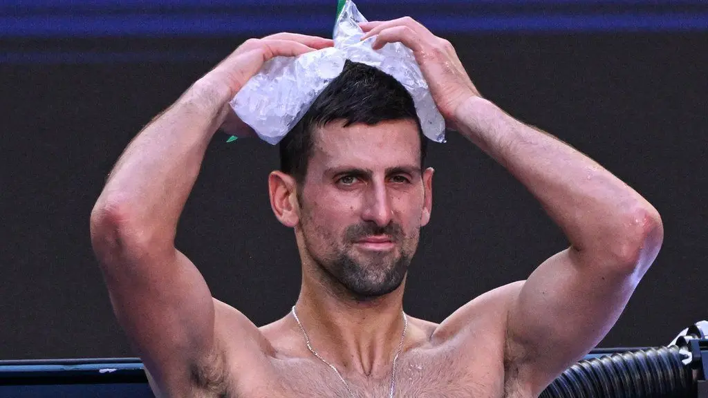 Novak Djokovic holds an ice pack to his head