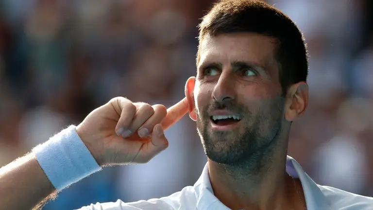 Novak Djokovic of Serbia reacts during his quarterfinal against Taylor Fritz of the U.S. at the Australian Open tennis championships at Melbourne Park, Melbourne, Australia, Tuesday, Jan. 23, 2024. (AP Photo/Asanka Brendon Ratnayake)