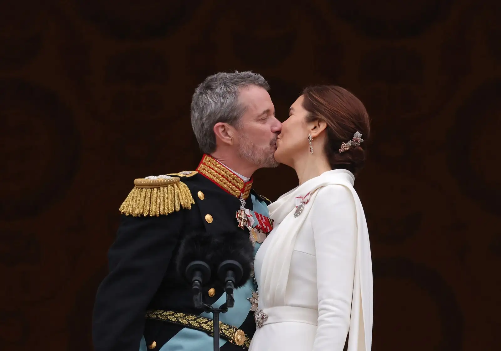 King Frederik X and Queen Mary share a kiss during the coronation