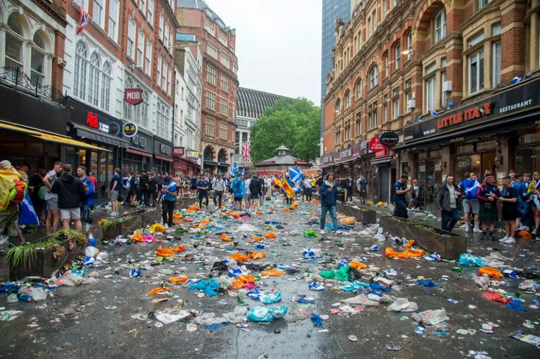 A general view of Leicester Square in London showing the street covered with bottles, cans and plastic bags