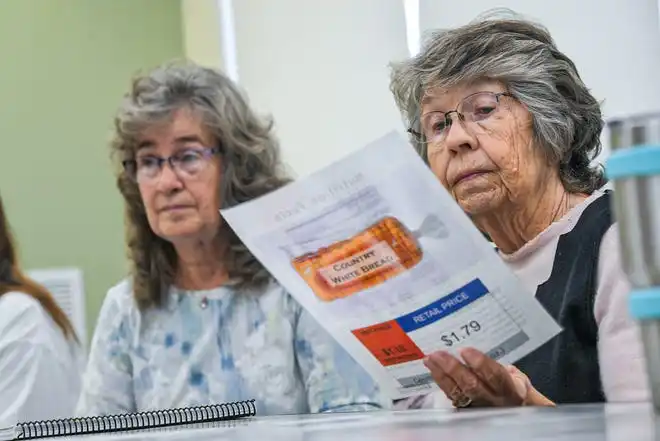 Sandy Hochstetler, right, looks at nutrition information for bread during the Clemson SNAP-ED program Cooking Matters! class, teaching nutrition and recipes in a class at Belton Library Tuesday, January 23, 2024. The cooking educational class shares ideas for mindful eating.