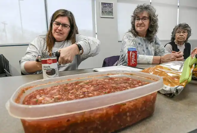 Crystal Greene, left, opens a can of black beans before making black bean and vegetable quesadilla during a Clemson SNAP-ED program Cooking Matters! class, teaching nutrition and recipes in a class at Belton Library Tuesday, January 23, 2024.