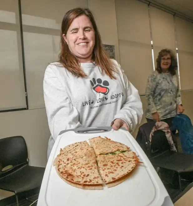 Crystal Greene shows a finished black bean and vegetable quesadilla during a Clemson SNAP-ED program Cooking Matters! class, teaching nutrition and recipes in a class at Belton Library Tuesday, January 23, 2024.