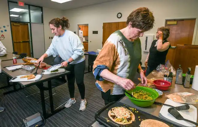 Anderson County Health Educator Sarah Donnald, left, and Carol Coddington, and other participants, make black bean and vegetable quesadillas during a Clemson SNAP-ED program Cooking Matters! class, teaching nutrition and recipes in a class at Belton Library Tuesday, January 23, 2024.