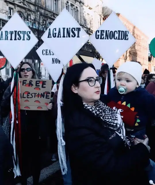 Kerry attending an Artists Against Genocide protest with her godson Cailan. Photo credit: Peadar Whelan