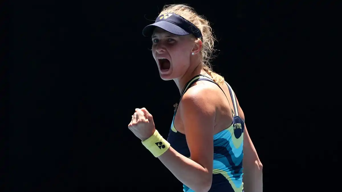 Tennis player Dayana Yastremska, shouting celebration, with a clenched left fist.