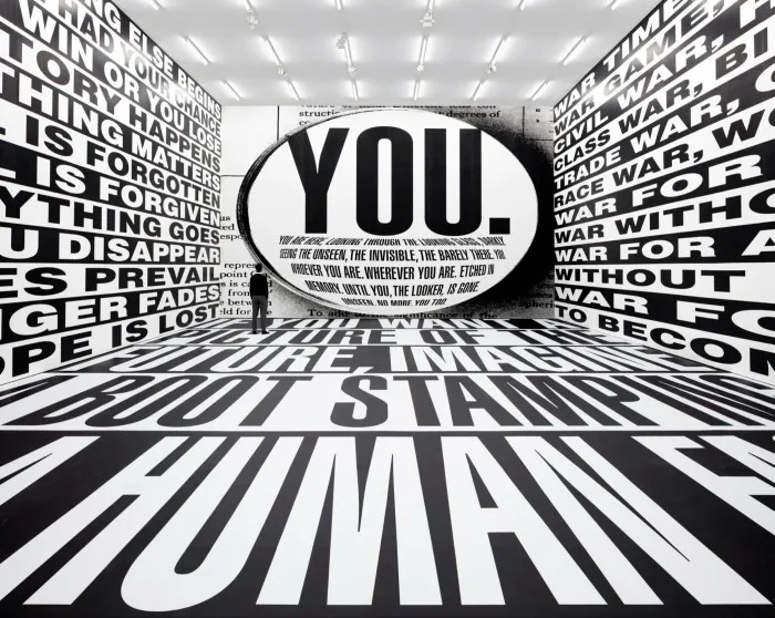 Large-scale text collage in gallery with central word ‘You’