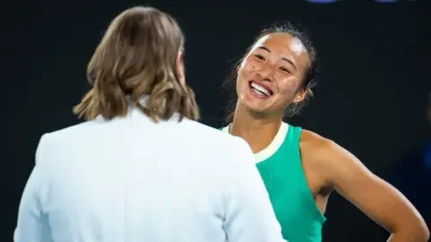 Getty Images Zheng speaking to an interviewer in her post-match chat after her semi-final victory on 25 January