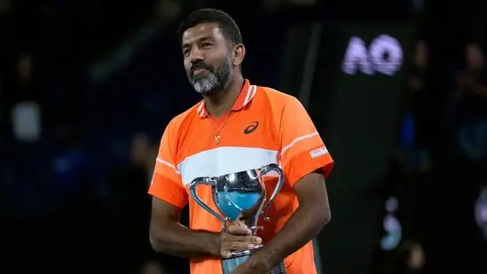 Rohan Bopanna of India holds his trophy after he and partner Matthew Ebden of Australia defeated Simone Bolelli and Andrea Vavassori of Italy in the men's doubles final at the Australian Open tennis championships (AP)