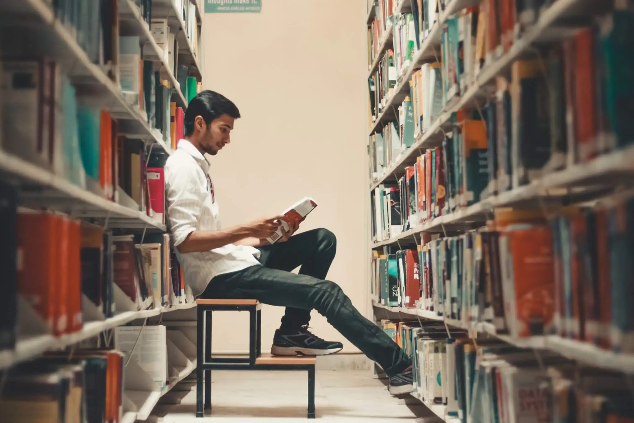 Man reading book in library