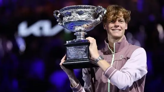 Italy's Jannik Sinner celebrates with the Norman Brookes Challenge Cup trophy after defeating Russia's Daniil Medvedev (AFP)