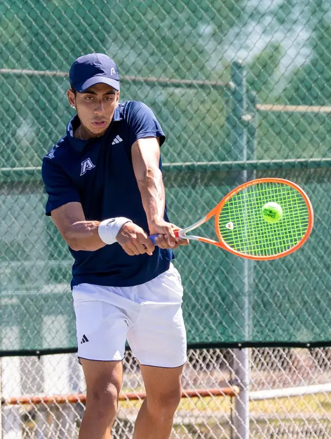 Man swinging a tennis racket