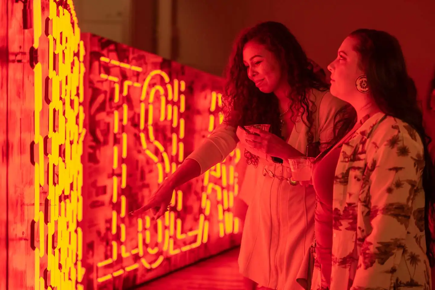 Two women look at an art installation