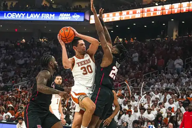 Texas forward Brock Cunningham, left, shoots over Houston's  Joseph Tugler during Houston's ??-?? win Monday at Moody Center.